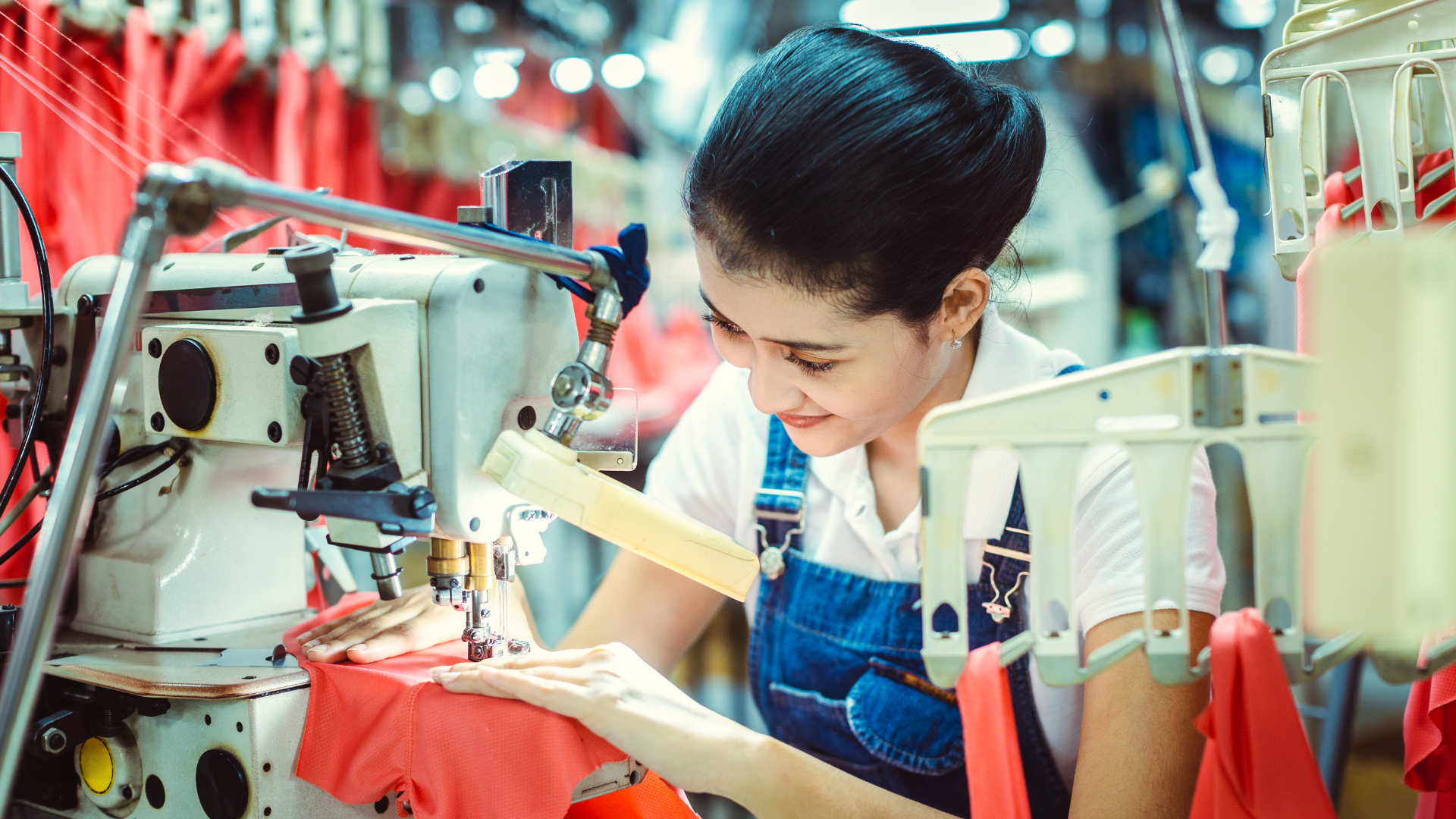 Machinist sewing navy fabric in a garment workshop